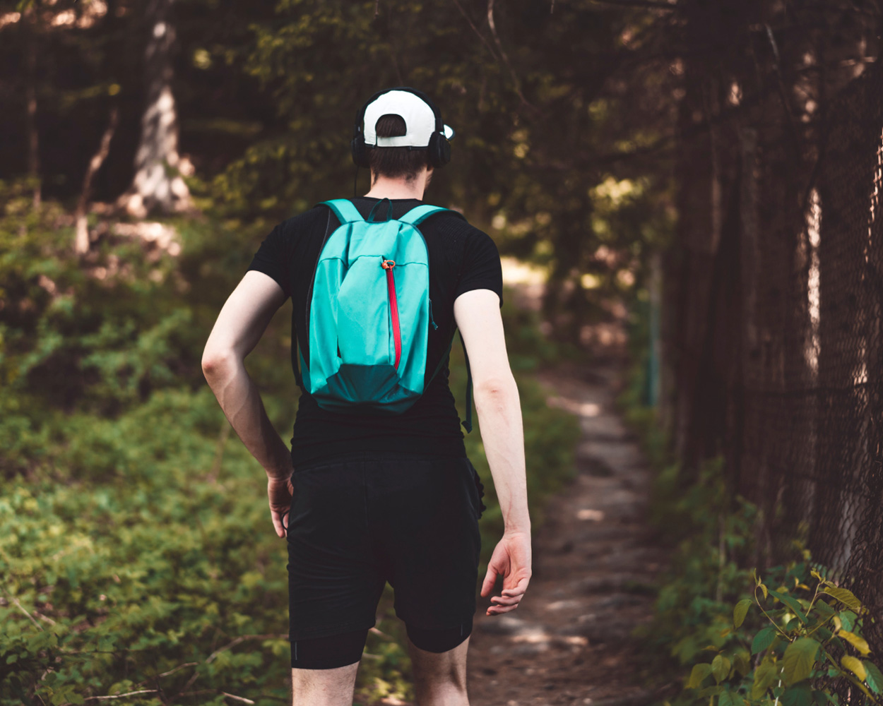 Gay man walking in nature as he navigates difficult life transitions